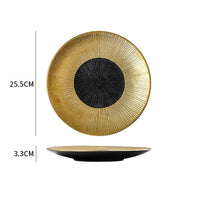 Decorative plate with gold rim and black center, showing measurements on a white background